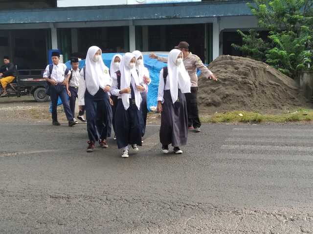 Pastikan Aman, Polsek Pamotan dan Satpam Sigap Seberangkan Siswa